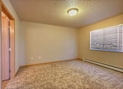 Thumbnail 8 of 12 - the upstairs bedroom has a large window and carpeted floor. Fargo, ND East Bridge Apartments