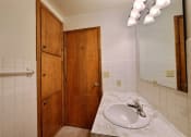 Thumbnail 11 of 12 - a bathroom with a sink and cabinet. Fargo, ND Emerald Apartments