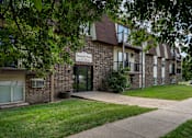 Thumbnail 21 of 21 - A brick building with a sign. Bismarck, ND Belmont West Apartments