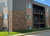 Thumbnail 16 of 17 - A modern building with a balcony and a brick facade. Grand Forks, ND Cedarwood Apartments