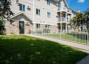 Thumbnail 43 of 43 - apartment with an office sign above the door. Bismarck, ND Sierra Ridge Apartments