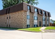 Thumbnail 7 of 7 - A brick building with a brown roof. Bismarck, ND Arbor 400 Apartments