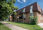 Thumbnail 20 of 21 - A brick building with a balcony on the second floor. Bismarck, ND Belmont East Apartments