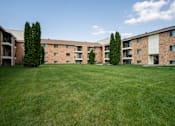 Thumbnail 38 of 39 - A grassy area in front of apartment buildings. Grand Forks, ND Columbia West Apartments
