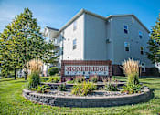 Thumbnail 29 of 31 - A building with a sign that says Stoneridge in front of it. Fargo, ND Stonebridge Apartments