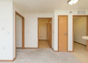 Thumbnail 7 of 21 - a hallway with doors to bedrooms and bathrooms with a closet. Fargo, ND Sunrise North
