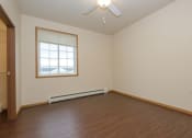 Thumbnail 13 of 23 - a bedroom with wooden floors and a window. Fargo, ND North Sky Apartments