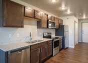 Thumbnail 12 of 25 - a kitchen with stainless steel appliances and a granite counter top. Fargo, ND 29 West Apartments