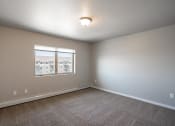 Thumbnail 9 of 25 - a bedroom with carpet and a window. Fargo, ND 29 West Apartments