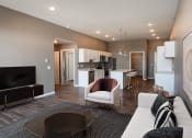 Thumbnail 2 of 25 - a living room and kitchen with a couch and a tv. Fargo, ND 29 West Apartments