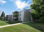 Thumbnail 10 of 10 - the exterior of an apartment building with grass and a sidewalk