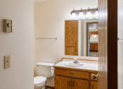 Thumbnail 11 of 13 - a bathroom with a toilet sink and mirror. Fargo, ND Auburn II Apartments