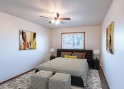 Thumbnail 5 of 13 - a bedroom with a large bed and a ceiling fan. Fargo, ND Auburn II Apartments