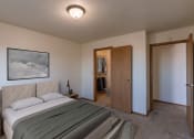 Thumbnail 4 of 13 - a bedroom with a bed and a closet. Fargo, ND Auburn II Apartments.