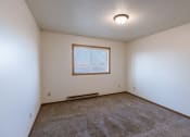Thumbnail 9 of 13 - a bedroom with carpeted floors and a window. Fargo, ND Auburn II Apartments