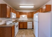 Thumbnail 7 of 13 - a kitchen with white appliances and wooden cabinets. Fargo, ND Auburn II Apartments