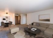 Thumbnail 3 of 13 - a living room with a couch and a coffee table and a dining room. Fargo, ND Auburn II Apartments