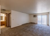 Thumbnail 6 of 13 - the living room of an empty apartment with a sliding glass door. Fargo, ND Auburn II Apartments