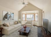 Thumbnail 1 of 13 - Fargo, ND Bayview Apartments. A living room with a vaulted ceiling and a large window