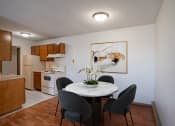 Thumbnail 2 of 15 - a dining room with a table and chairs and a kitchen. Fargo, ND Bella Vista Apartments
