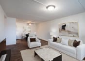 Thumbnail 4 of 15 - a living room with white couches and chairs and a table. Fargo, ND Bella Vista Apartments