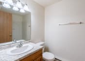 Thumbnail 8 of 9 - a bathroom with a sink and a mirror and a toilet. Fargo, ND Berkshire Apartments