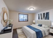 Thumbnail 3 of 9 - a bedroom with a white bed and a blue blanket. Fargo, ND Berkshire Apartments