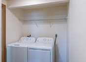 Thumbnail 9 of 9 - an empty laundry room with  a washer and a dryer. Fargo, ND Berkshire Apartments