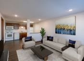 Thumbnail 2 of 9 - a living room with a couch and a table and a kitchen. Fargo, ND Berkshire Apartments