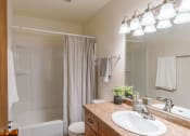 Thumbnail 13 of 25 - a bathroom with a sink and a shower and a toilet. Fargo, ND Betty Ann Apartments