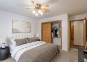Thumbnail 3 of 25 - a bedroom with a bed and a ceiling fan. Fargo, ND Betty Ann Apartments