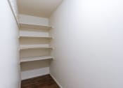 Thumbnail 12 of 25 - an empty closet in a room with wooden floors and white walls. Fargo, ND Betty Ann Apartments