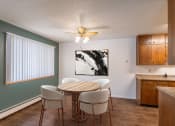 Thumbnail 2 of 25 - a dining room with a table and chairs and a ceiling fan. Fargo, ND Betty Ann Apartments