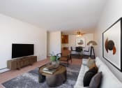 Thumbnail 4 of 25 - a living room with a white couch and a television. Fargo, ND Betty Ann Apartments