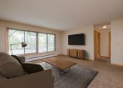 Thumbnail 2 of 16 - a living room with a couch and a coffee table. Fargo, ND Birchwood 2 Apartments
