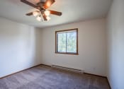 Thumbnail 8 of 26 - a bedroom with a ceiling fan and a window. Fargo, ND Briar Pointe Apartments