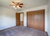 Thumbnail 10 of 26 - a bedroom with carpet and a ceiling fan. Fargo, ND Briar Pointe Apartments