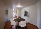 Thumbnail 2 of 26 - a dining room area with a table and chairs and a living room in the background. Fargo, ND Briar Pointe Apartments