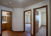 Thumbnail 13 of 26 - a hallway with two doors into a bedroom and a bathroom. Fargo, ND Briar Pointe Apartments