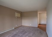 Thumbnail 4 of 26 - an empty living room with a tv on the wall. Fargo, ND Briar Pointe Apartments