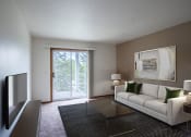 Thumbnail 1 of 26 - a living room with a white couch and a glass table. Fargo, ND Briar Pointe Apartments