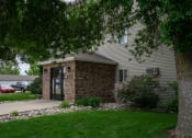 Thumbnail 26 of 26 - a side view of a house with a tree and a sidewalk. Fargo, ND Briar Pointe Apartments