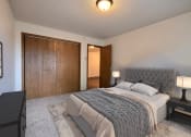 Thumbnail 7 of 33 - Fargo, ND Brownstone Apartments. a bedroom with a bed and a wardrobe