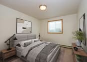Thumbnail 4 of 17 - Fargo, ND Cambridge Apartments a bedroom with a large bed and a window