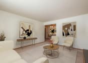 Thumbnail 2 of 17 - Fargo, ND Cambridge Apartments a living room with white furniture and abstract art on the walls