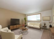 Thumbnail 1 of 17 - Fargo, ND Cambridge Apartments a living room filled with furniture and a flat screen tv
