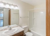 Thumbnail 11 of 17 - Fargo, ND Cambridge Apartments. A bathroom with a sink toilet and bathtub