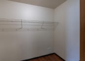 Thumbnail 17 of 41 - a bedroom with a white wall and a hanging rack on the wall. Fargo, ND Carlton Place Apartments