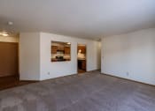 Thumbnail 10 of 41 - the living room and dining room of an empty apartment with white walls. Fargo, ND Carlton Place Apartments