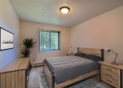 Thumbnail 3 of 10 - a bedroom with a bed and a dresser and a window. Fargo, ND Chestnut Ridge Apartments